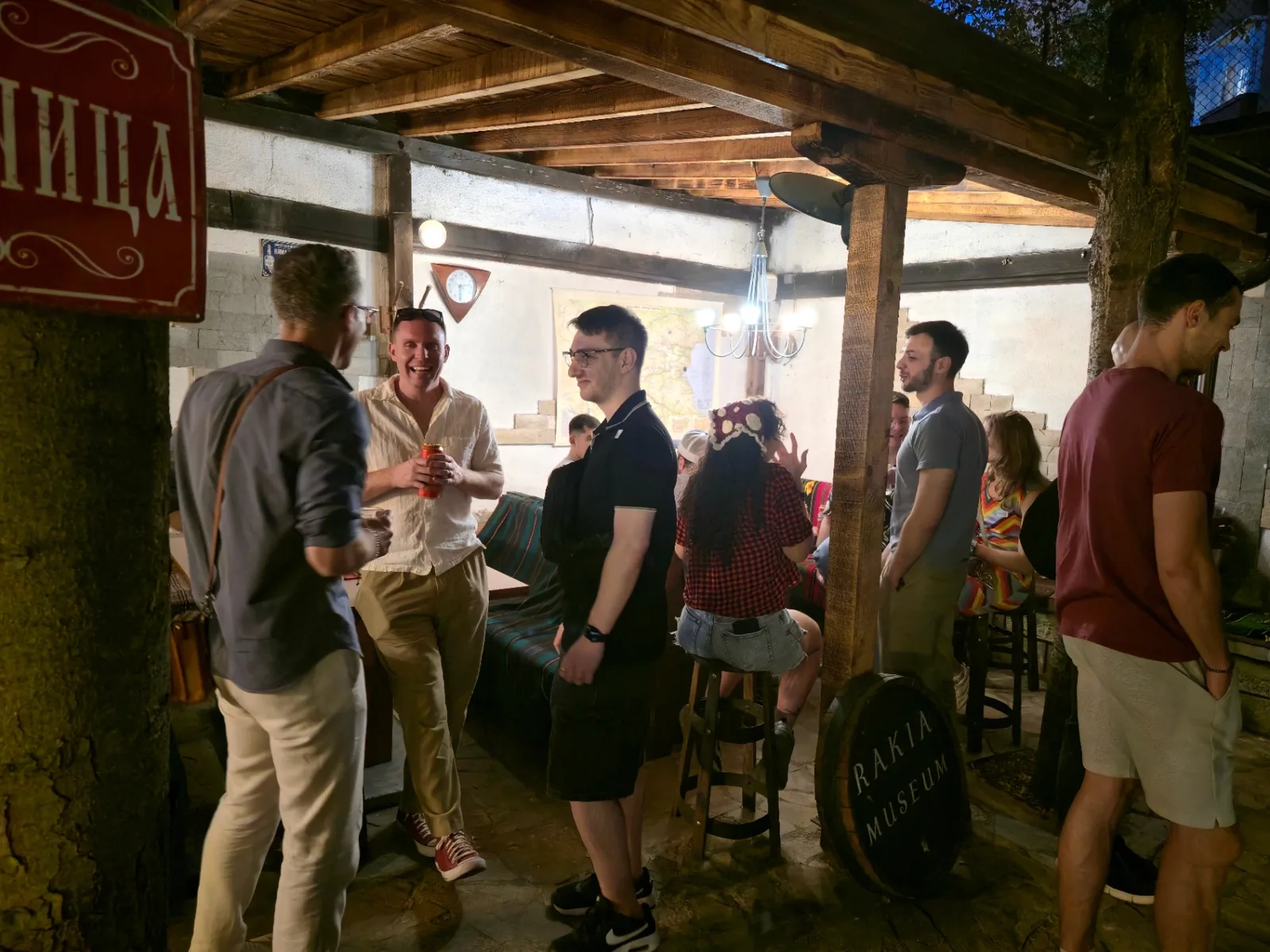 International mixer crowd at Rakia Museum in Sofia standing around barrel tables