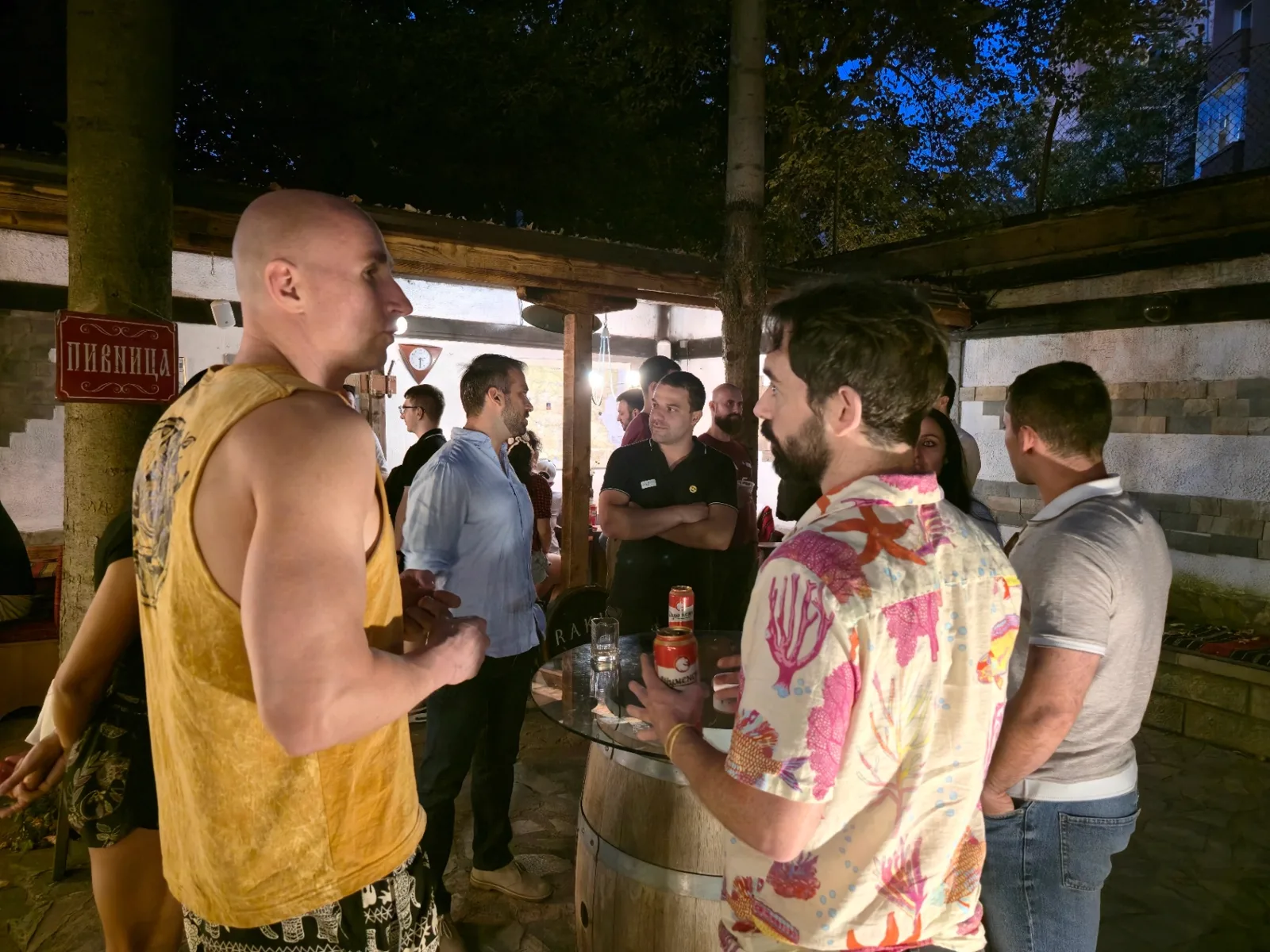 Expats and locals socializing at a Sofia Meetups event on the Rakia Museum patio