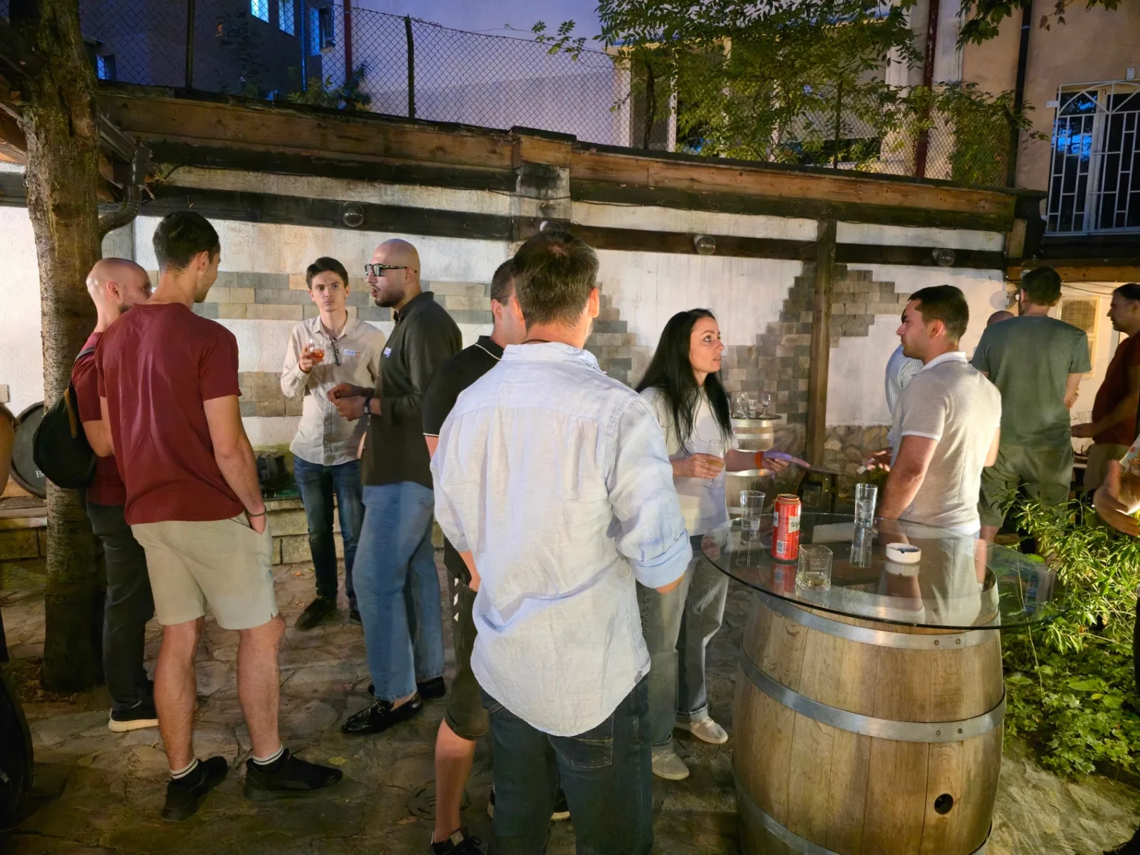 Expats and locals enjoying drinks at Rakia Museum Sofia in the garden courtyard