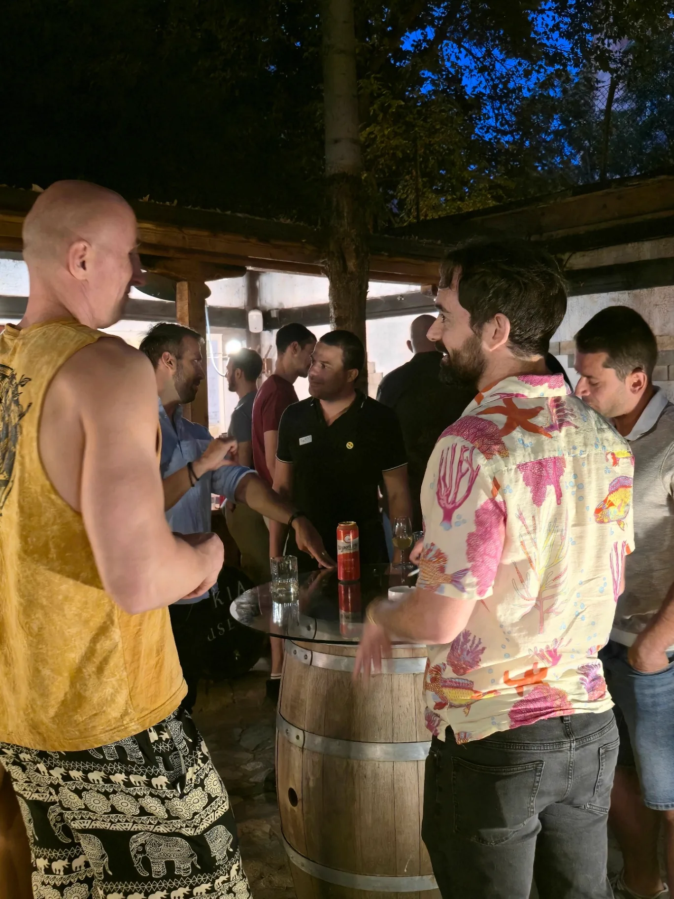 International guests chatting around a barrel table at Sofia Meetups